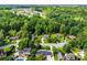 An aerial view showcases a community of homes nestled amongst lush greenery, creating a serene neighborhood atmosphere at 118 Creek Hollow Trl, Belmont, NC 28012