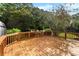 Enjoy outdoor living on this wood deck, overlooking a lush backyard with mature trees and ample privacy at 118 Creek Hollow Trl, Belmont, NC 28012