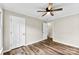 Bedroom with light walls, wood-look floors, lots of light and a modern ceiling fan at 118 Creek Hollow Trl, Belmont, NC 28012