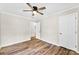 Bedroom with light walls, wood-look floors, lots of light and a modern ceiling fan at 118 Creek Hollow Trl, Belmont, NC 28012