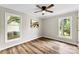 Bedroom with light walls, wood-look floors, lots of light and a modern ceiling fan at 118 Creek Hollow Trl, Belmont, NC 28012