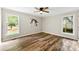 This bedroom features beautiful wood-look flooring, natural light, and a ceiling fan at 118 Creek Hollow Trl, Belmont, NC 28012