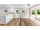 Charming dining area with bay window, wood plank flooring, and white wainscoting at 118 Creek Hollow Trl, Belmont, NC 28012