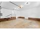 Spacious garage featuring brick wainscoting, ample lighting, and concrete flooring for a functional workspace at 118 Creek Hollow Trl, Belmont, NC 28012
