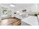 Bright kitchen with white cabinets, wood plank floors, and modern appliances at 118 Creek Hollow Trl, Belmont, NC 28012