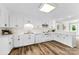 Well-lit kitchen with white cabinetry, wood plank flooring, and modern amenities at 118 Creek Hollow Trl, Belmont, NC 28012