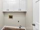 Functional laundry room with white cabinets and wood plank flooring at 118 Creek Hollow Trl, Belmont, NC 28012