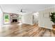Spacious living room featuring a cozy fireplace, wood plank flooring, and bright natural light at 118 Creek Hollow Trl, Belmont, NC 28012