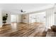 Inviting living room with wood plank flooring open to the kitchen, and neutral paint colors at 118 Creek Hollow Trl, Belmont, NC 28012