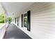 Inviting front porch showcasing classic design, white columns and a dark gray floor, creating great curb appeal at 118 Creek Hollow Trl, Belmont, NC 28012