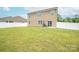 Expansive backyard with healthy green grass and a patio, perfect for outdoor entertaining at 128 Hickory Ridge Dr, Locust, NC 28097