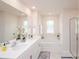 Bright bathroom featuring double vanity, soaking tub, and glass enclosed shower at 128 Hickory Ridge Dr, Locust, NC 28097
