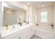 Bright bathroom featuring double vanity, soaking tub, and a walk-in shower at 128 Hickory Ridge Dr, Locust, NC 28097