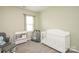 Adorable Bedroom with a crib, changing table, and cozy rocker at 128 Hickory Ridge Dr, Locust, NC 28097