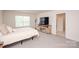 Bedroom with a queen bed, tv stand with tv, and a window that provides natural light at 128 Hickory Ridge Dr, Locust, NC 28097