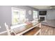 Cozy dining room with bench seating, sliding glass doors, and a decorative wall clock at 128 Hickory Ridge Dr, Locust, NC 28097