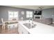 Open concept kitchen and living area with a large island, stainless steel appliances, and modern finishes at 128 Hickory Ridge Dr, Locust, NC 28097