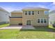 Backyard with grass area, patio and two-story home at 128 Yellowbell Rd, Mooresville, NC 28117