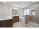 Bathroom with double sink vanity, bathtub, and glass-enclosed shower at 128 Yellowbell Rd, Mooresville, NC 28117