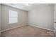 Cozy bedroom with neutral carpet, a bright window, and ample natural light at 128 Yellowbell Rd, Mooresville, NC 28117
