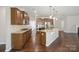 Open-concept kitchen with granite countertops, stainless appliances, and a large island at 128 Yellowbell Rd, Mooresville, NC 28117