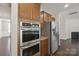 Kitchen features built-in oven, refrigerator, and ample wood cabinets at 128 Yellowbell Rd, Mooresville, NC 28117
