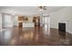 Open-concept living room and kitchen with wood floors and a fireplace at 128 Yellowbell Rd, Mooresville, NC 28117