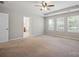 Spacious primary bedroom featuring tray ceiling and large windows at 128 Yellowbell Rd, Mooresville, NC 28117