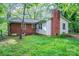 Backyard featuring a brick chimney and green grass at 1332 Midwood Dr, Gastonia, NC 28052