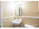 Half bathroom featuring cream-colored walls and a sink at 1332 Midwood Dr, Gastonia, NC 28052