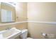 Powder room featuring a toilet and sink at 1332 Midwood Dr, Gastonia, NC 28052