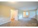 Bedroom featuring neutral carpet, closet, and a window at 1332 Midwood Dr, Gastonia, NC 28052