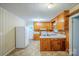 Functional kitchen featuring classic wood cabinets, white appliances, and durable countertops at 1332 Midwood Dr, Gastonia, NC 28052