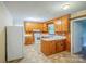 Functional kitchen featuring classic wood cabinets, white appliances, and durable countertops at 1332 Midwood Dr, Gastonia, NC 28052
