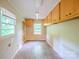 Utility room with storage cabinets and a view of the backyard at 1332 Midwood Dr, Gastonia, NC 28052