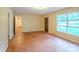 Sunlit living room featuring hardwood floors and a large window offering a view of the front yard at 1332 Midwood Dr, Gastonia, NC 28052