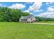 Spacious backyard featuring a well-maintained lawn, mature trees, and the home's screened-in porch at 1347 Norman Dr, Rock Hill, SC 29732