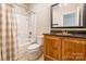 Cozy bathroom featuring a shower and tub with a shower curtain and a wood vanity at 1347 Norman Dr, Rock Hill, SC 29732