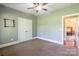 Spacious bedroom featuring neutral walls and carpet, a ceiling fan, and a double door closet at 1347 Norman Dr, Rock Hill, SC 29732