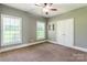 A well-lit bedroom features two windows, a ceiling fan, and a closet with double doors at 1347 Norman Dr, Rock Hill, SC 29732