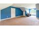 Upstairs bonus room with bright blue walls and carpet has two closets at 1347 Norman Dr, Rock Hill, SC 29732