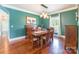 Dining room with wood table and chairs, chandelier and view to the adjacent hallway at 1347 Norman Dr, Rock Hill, SC 29732