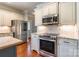 Modern kitchen showcasing stainless steel appliances, granite countertops, and natural wood floors at 1347 Norman Dr, Rock Hill, SC 29732