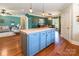Open concept kitchen with island, natural wood floors and view into the living and dining rooms at 1347 Norman Dr, Rock Hill, SC 29732
