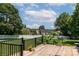 Wooden deck overlooking a grassy backyard with a white fence and lush greenery at 139 Hardwick Dr, Mooresville, NC 28115
