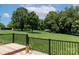 Backyard view from the deck, showing expansive green lawn, mature trees, and a serene setting at 139 Hardwick Dr, Mooresville, NC 28115