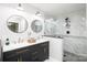 Modern bathroom featuring double sinks, black vanity with gold pulls, glass enclosed shower with tile surround and floors at 139 Hardwick Dr, Mooresville, NC 28115