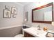 Charming half-bath with a traditional vanity, decorative mirror, and stylish wall decor at 139 Hardwick Dr, Mooresville, NC 28115