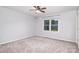 Spacious bedroom with neutral carpet, ceiling fan and a window with a view of trees at 139 Hardwick Dr, Mooresville, NC 28115