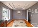 Elegant dining room featuring tray ceilings, hardwood floors, and chandelier at 139 Hardwick Dr, Mooresville, NC 28115